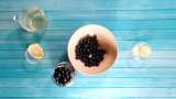 Aronia berries with lemon and ginger macerated in honey, in a jar - Preparation step 2