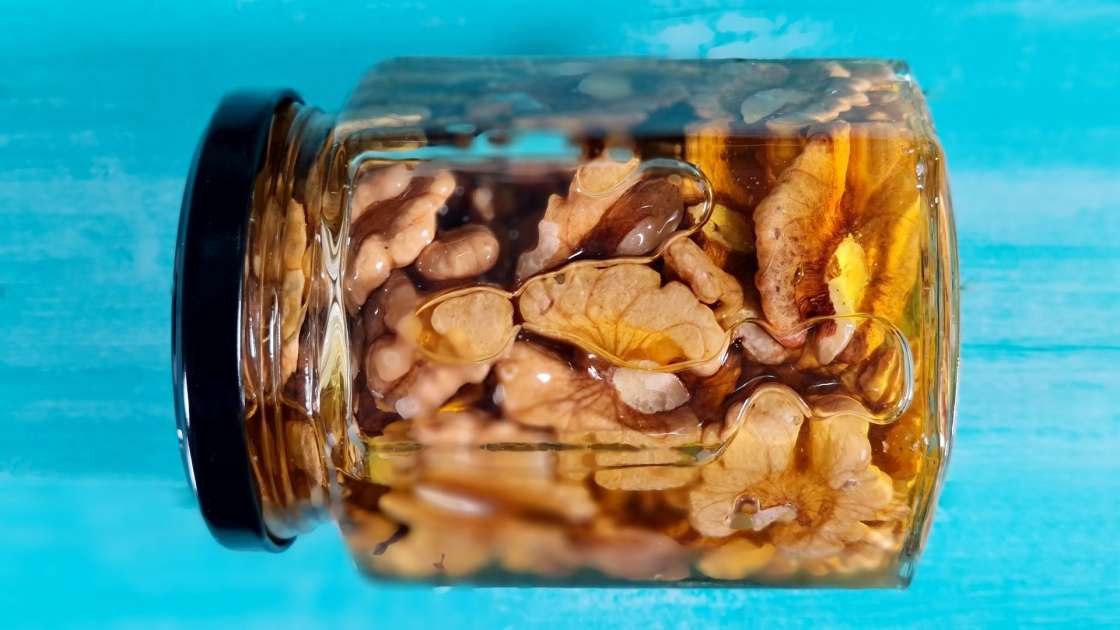 Walnut kernels with honey in a jar, photo 2