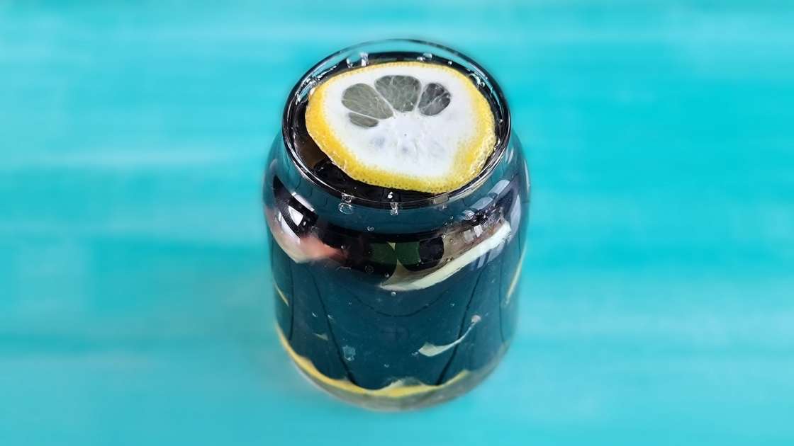 Aronia berries with lemon and ginger macerated in honey, in a jar, photo 2