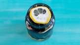 Aronia berries with lemon and ginger macerated in honey, in a jar